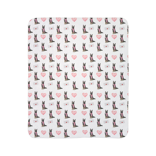 Close-up of sable German Shepherd Valentine's blanket pattern with pink hearts and love letters