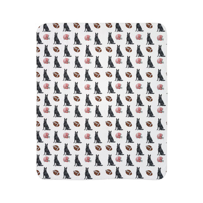 Close-up of black German Shepherd football blanket pattern with footballs and helmets