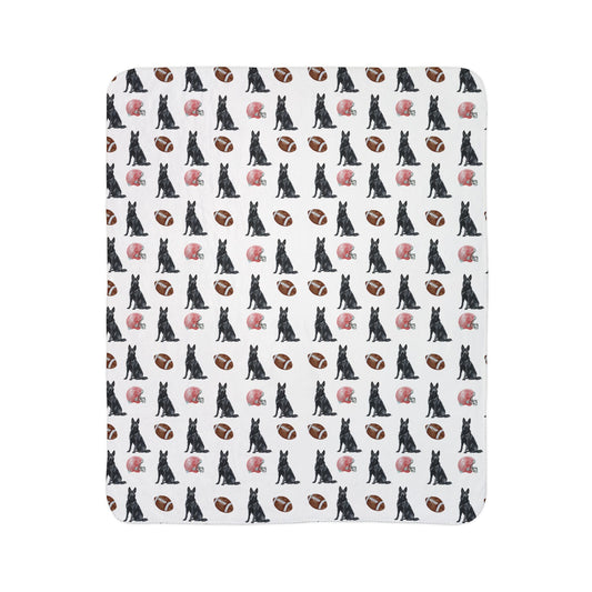 Close-up of black German Shepherd football blanket pattern with footballs and helmets