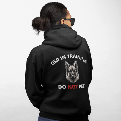 Woman wearing black GSD In Training Do Not Pet German Shepherd hoodie, back design view