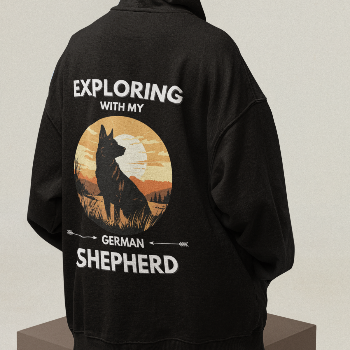 Man wearing German Shepherd Explore hoodie with outdoor adventure design