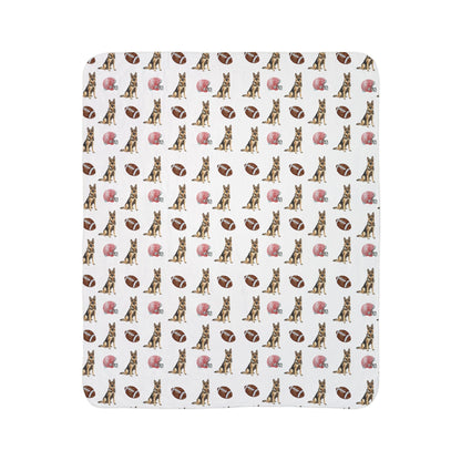 Close-up of German Shepherd football blanket pattern with footballs and helmets