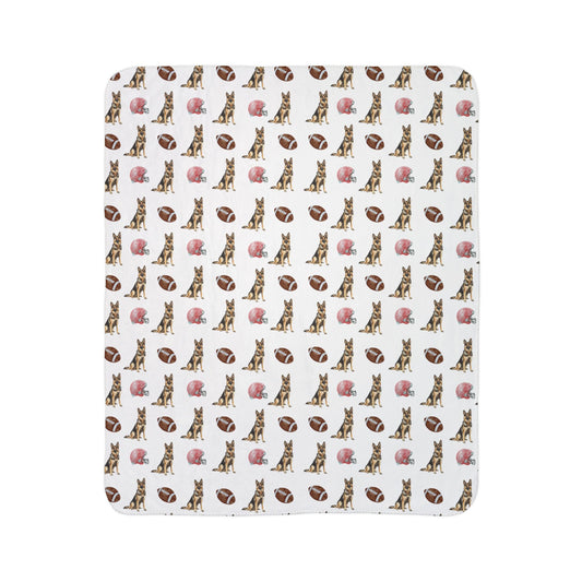 Close-up of German Shepherd football blanket pattern with footballs and helmets