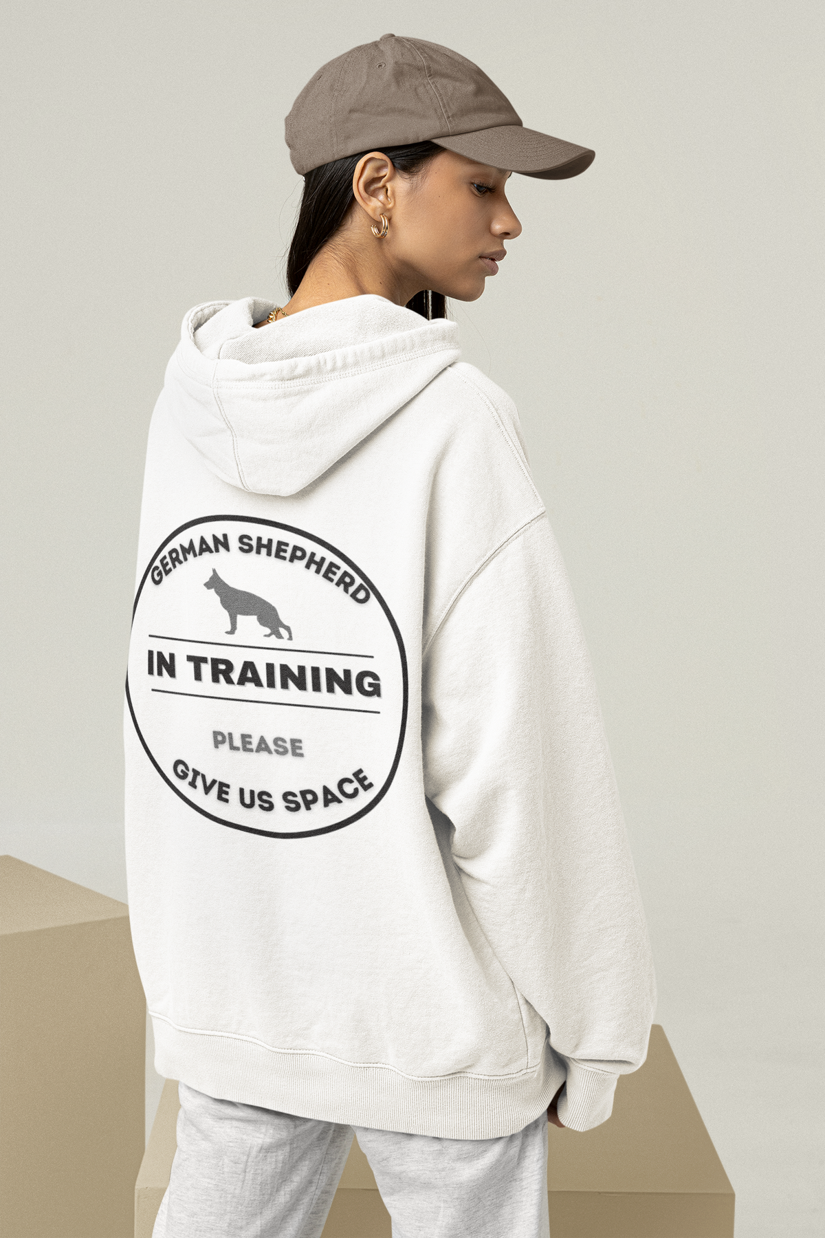 Hoodie with a circular badge on the back reading German Shepherd In Training, Please Give Us Space