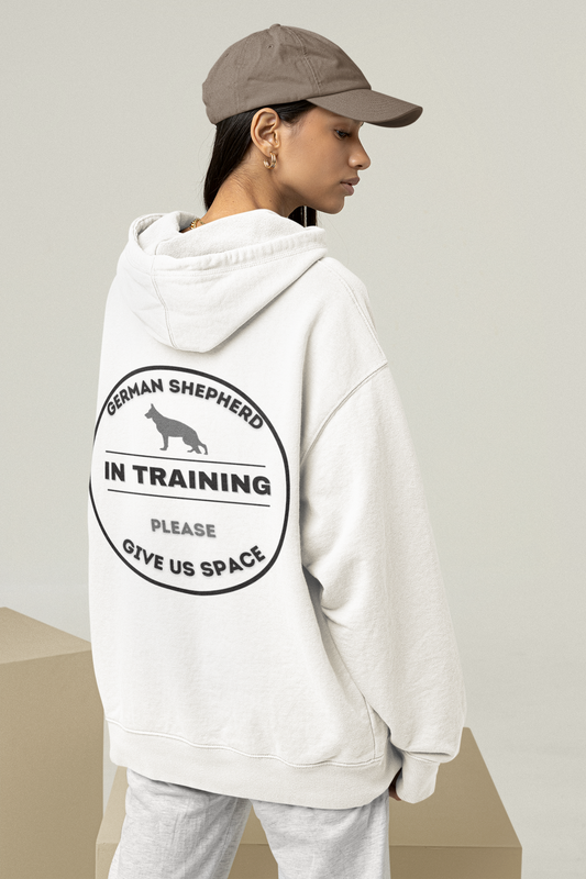 Hoodie with a circular badge on the back reading German Shepherd In Training, Please Give Us Space