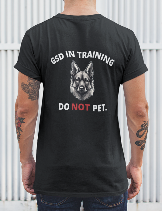 Man wearing black Do Not Pet Service Dog In Training German Shepherd t-shirt, back view
