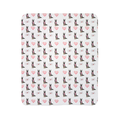 Close-up of sable German Shepherd Valentine's blanket pattern with pink hearts and love letters