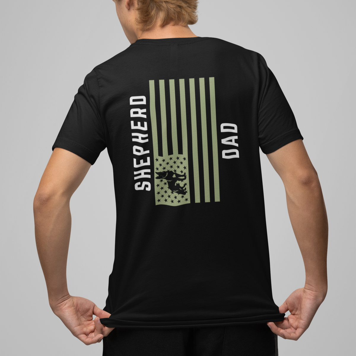 Man wearing black Shepherd Dad t-shirt, back print with olive American flag and German Shepherd