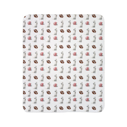 Close-up of white German Shepherd football blanket pattern with footballs and helmets