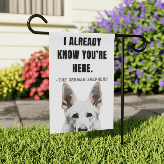 White Shepherd garden banner with “I Already Know You’re Here” design featuring a White Shepherd on a green grass background.