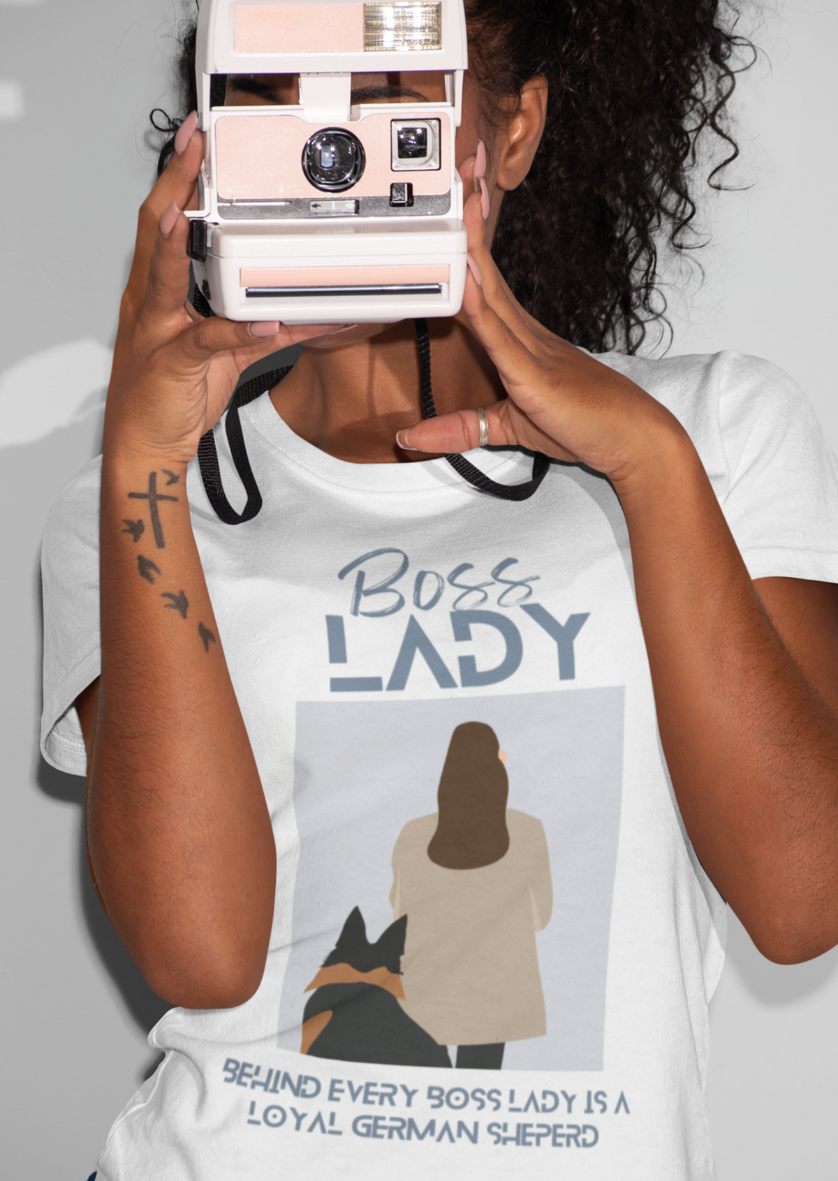 Woman holding vintage camera wearing white Boss Lady German Shepherd t-shirt